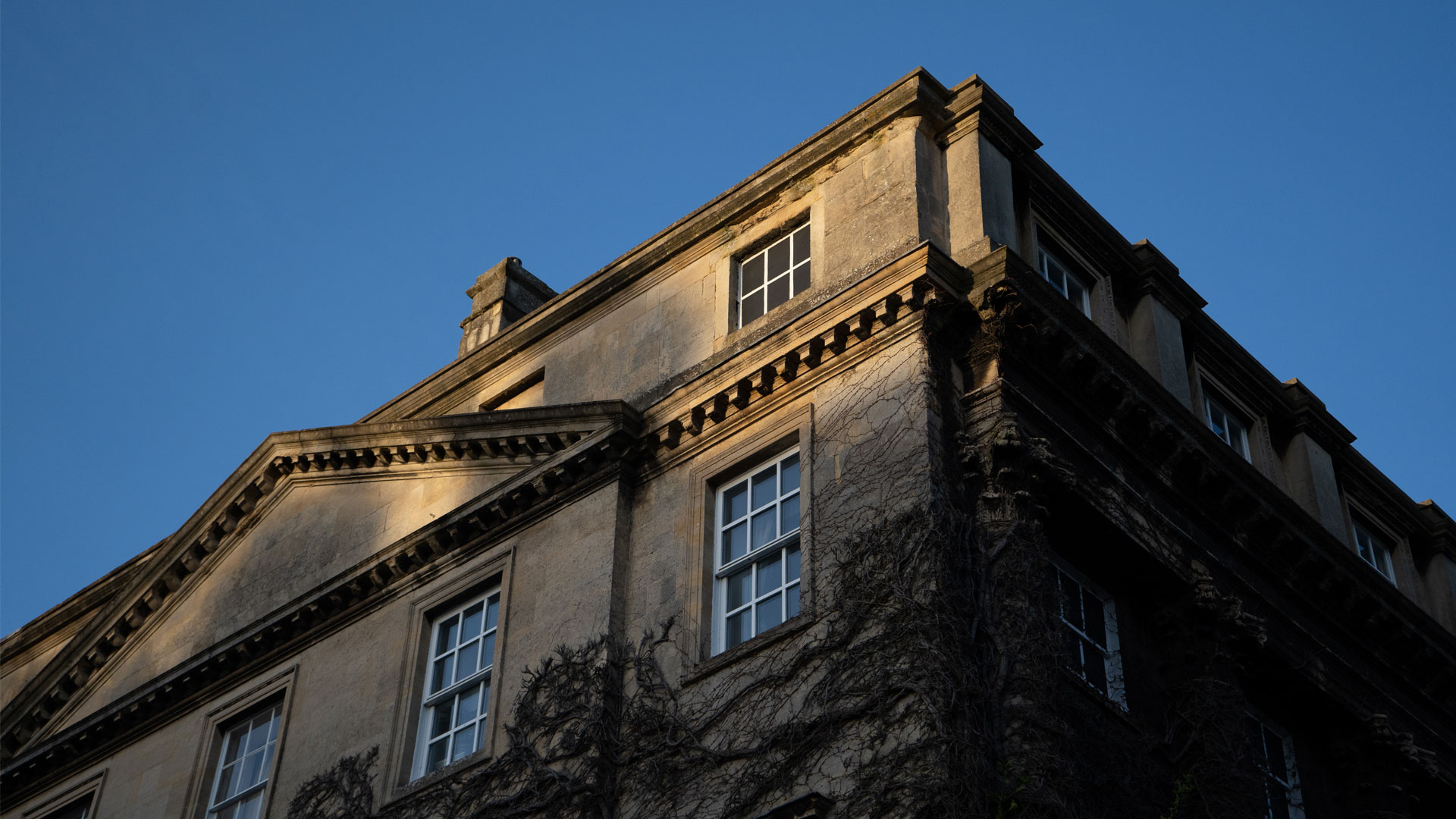 Image is a photograph of a building at sunset taken with a Sony A7 III.