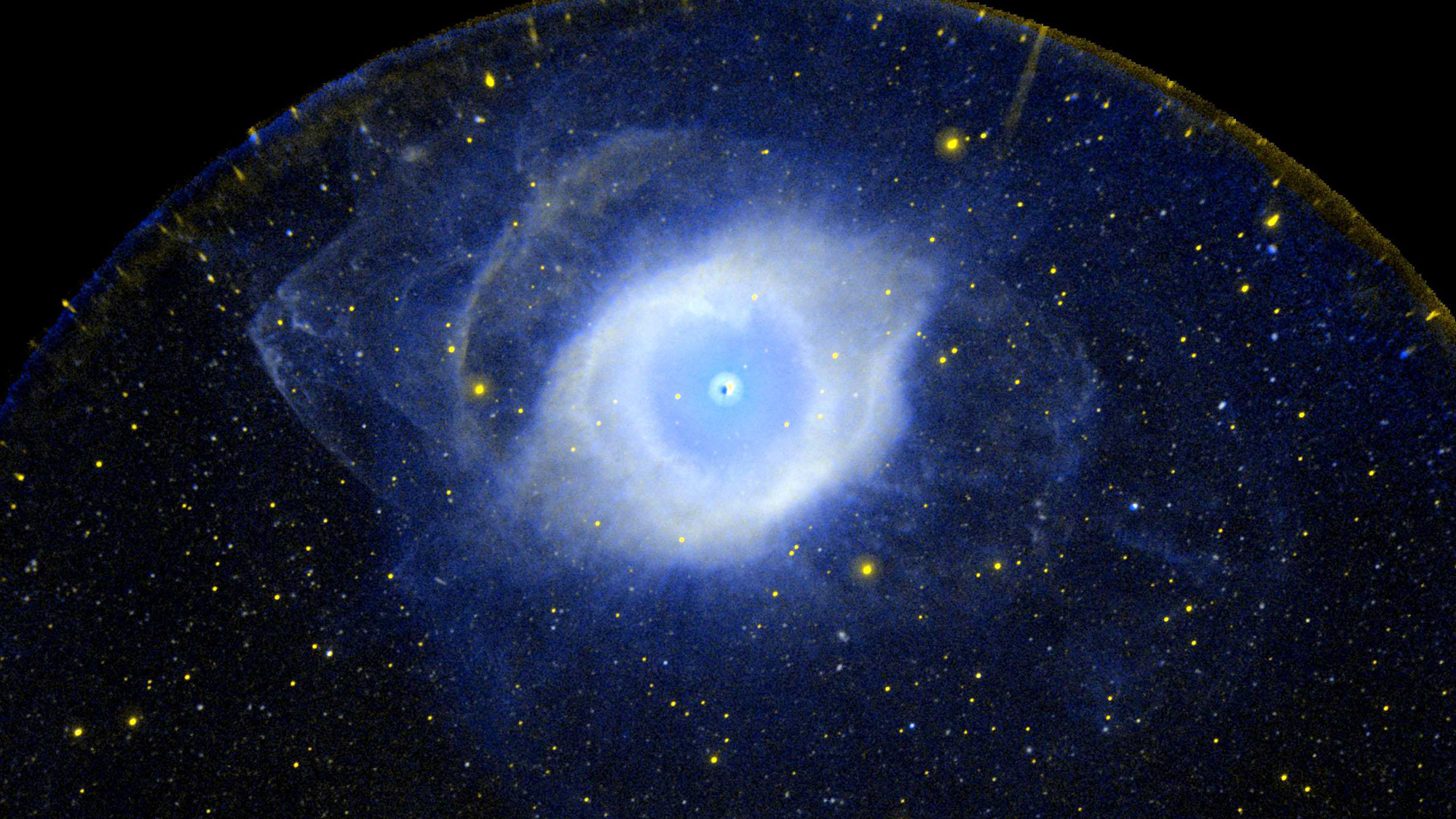 A glowing ball of blue light is seen in deep space.