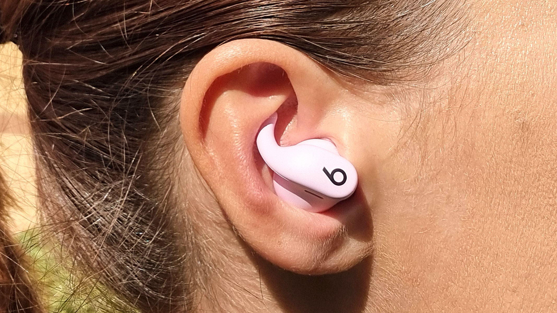 a close-up picture of our reviewer wearing the Beats Powerbeats Fit earbuds