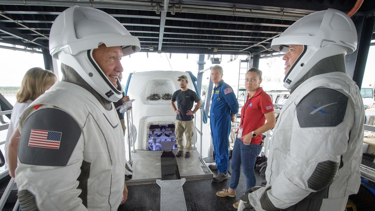 NASA astronauts Doug Hurley, left, and Bob Behnken work with teams from NASA and SpaceX to rehearse crew extraction from SpaceX’s Crew Dragon, which will be used to carry humans to the International Space Station, on August 13, 2019 at the Trident Basin in Cape Canaveral, Florida. Using the Go Searcher ship SpaceX uses to recover their spacecraft after splashdown and a mock-up of the Crew Dragon, the teams worked through the steps necessary to get NASA astronauts Doug Hurley and Bob Behnken out of the Dragon and back to dry land. Hurley and Behnken will fly to the space station aboard the Crew Dragon for the SpaceX Demo-2 mission.