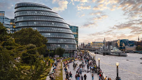 GLA Building and River Thames at sunset, with people walking on the riverfront in London, UK (Credit: Getty Images)