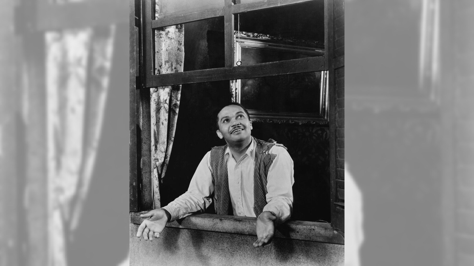American opera singer and actor Todd Duncan looking up as he leans on the ledge of an open window during a stage production of ‘Porgy and Bess’, staged at the Alvin Theatre in New York City, New York, 1935. Duncan plays the role of Porgy in the opera by American composer George Gershwin, with a libretto by DuBose Heyward and lyricist Ira Gershwin, adapted from the novel by DuBose Heyward. (Photo by Keystone/Hulton Archive/Getty Images)
